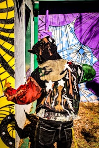 a man is painting a mural on a wall